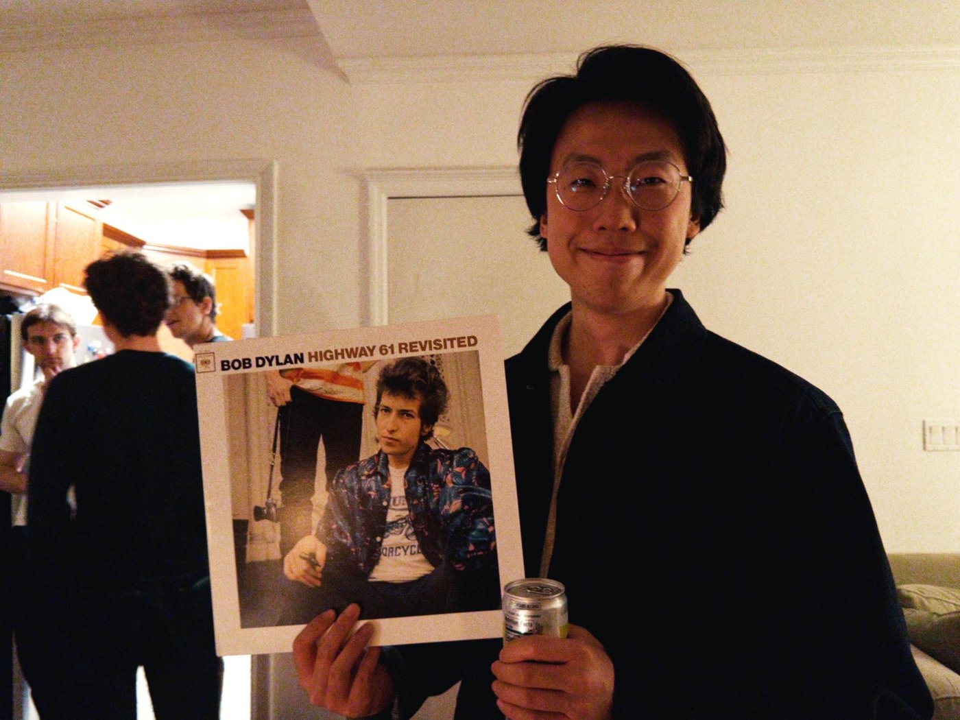 Weiming Sheng holding a copy of Bob Dylan&rsquo;s Highway 61 Revisited